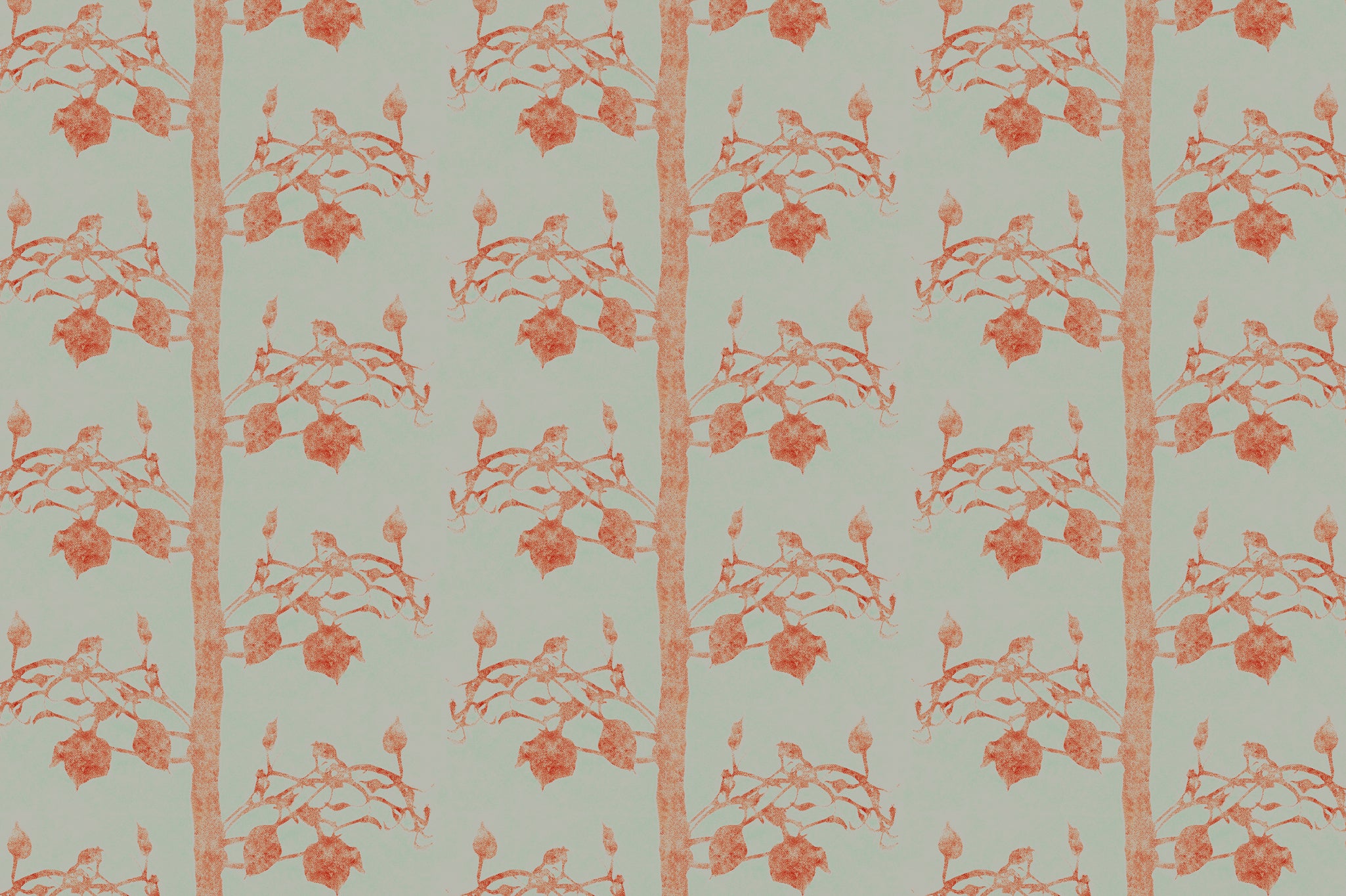 Detail of fabric in a linear tree and leaf print in burnt orange on a light green field.