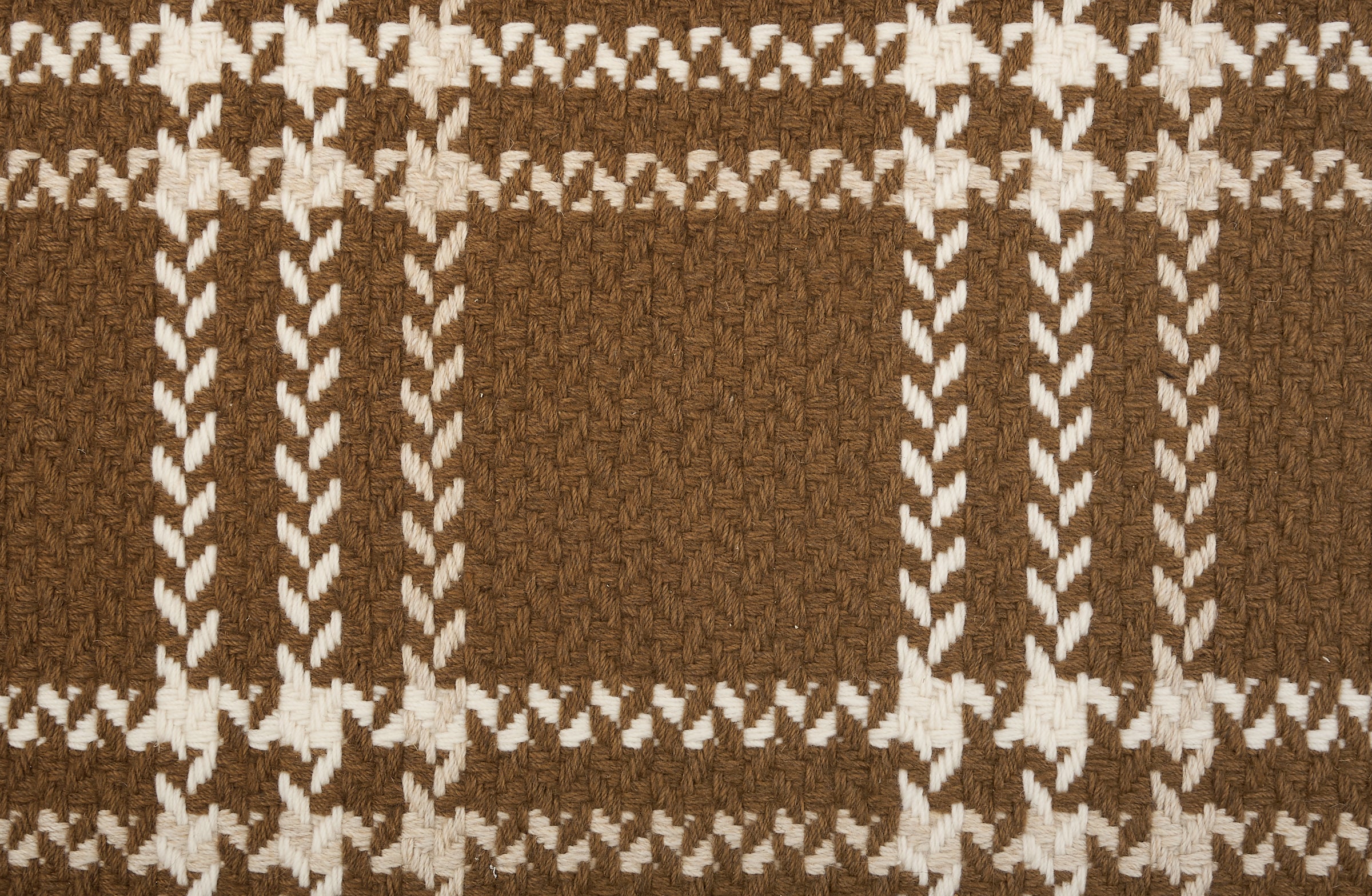 Broadloom carpet in a windowpane plaid in cream on a caramel brown field.