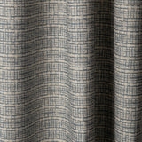 Draped linen fabric in a repeating abstract gridded pattern in navy on a cream field.