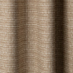 Draped linen fabric in a repeating abstract gridded pattern in tan on a cream field.