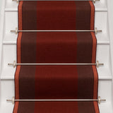 Striped flatweave runner in red and brown on white staircase
