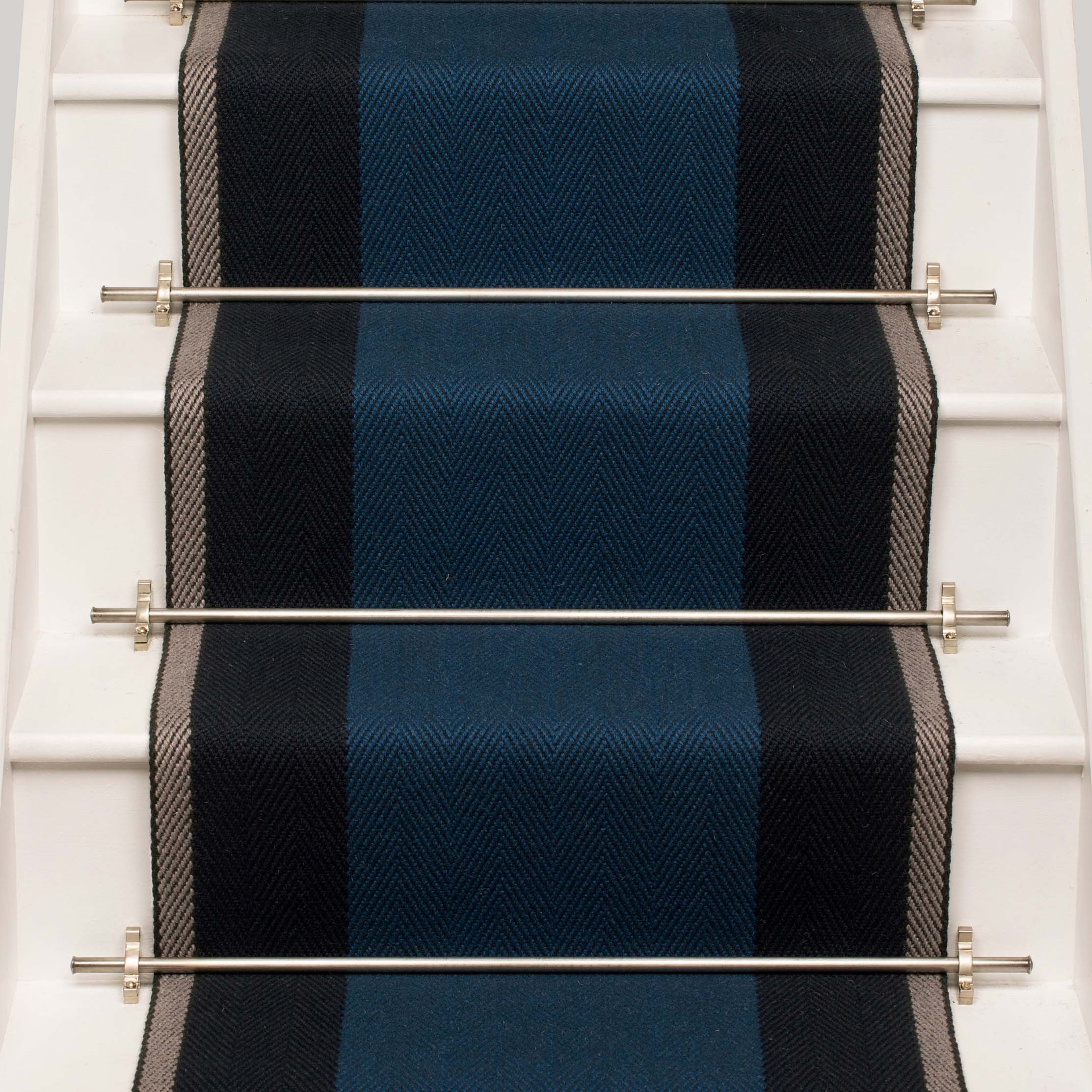 Striped flatweave runner in blue and grey on white staircase