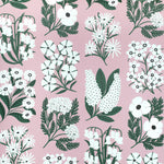 Detail of wallpaper in a minimalist floral grid print in white and green on a light pink field.