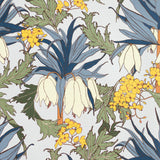 Detail of wallpaper in a dense floral print in shades of cream, yellow, green and blue on a white field.