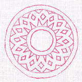 Detail of fabric in a repeating circular geometric print in fuchsia on a white field.