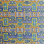 Close up of printed fabric with a complex geometric and striped pattern with yellow, blue, orange and pale blue 