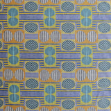 Close up of printed fabric with a complex geometric and striped pattern with yellow, blue, orange and pale blue 