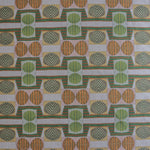 Close up of printed fabric with a complex geometric and striped pattern with orange, brown, grey and green.