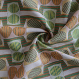 Close up of gently draped printed fabric with a complex geometric and striped pattern with orange, brown, grey and green.