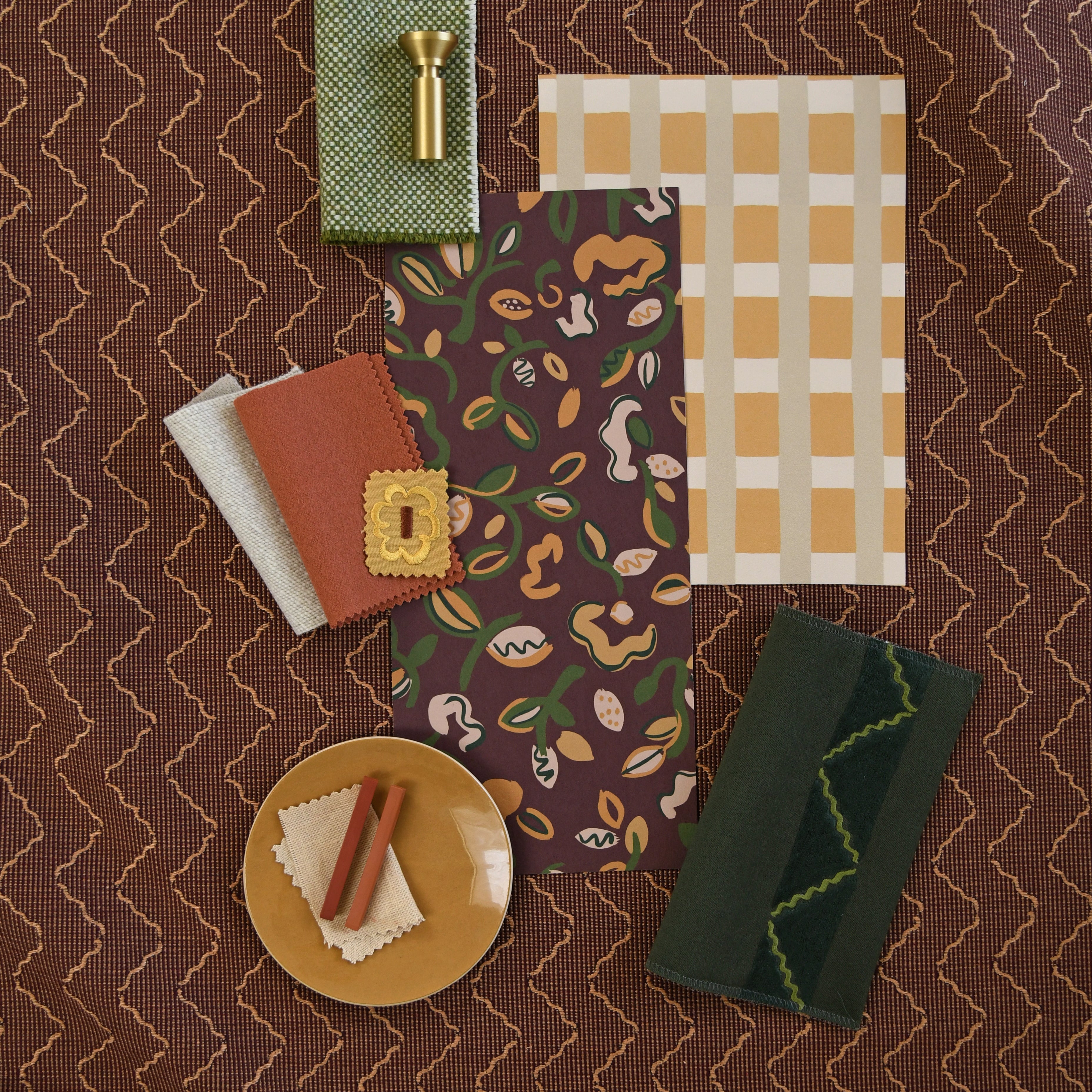 Moodboard with layered swatches of fabrics and inspiration images in palette of  brown, green and tan. 