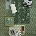 Moodboard with layered swatches of fabrics and inspiration images in palette of green