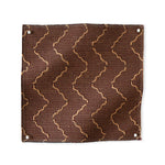 Pinned swatch of woven fabric with chevron stripe in brown
