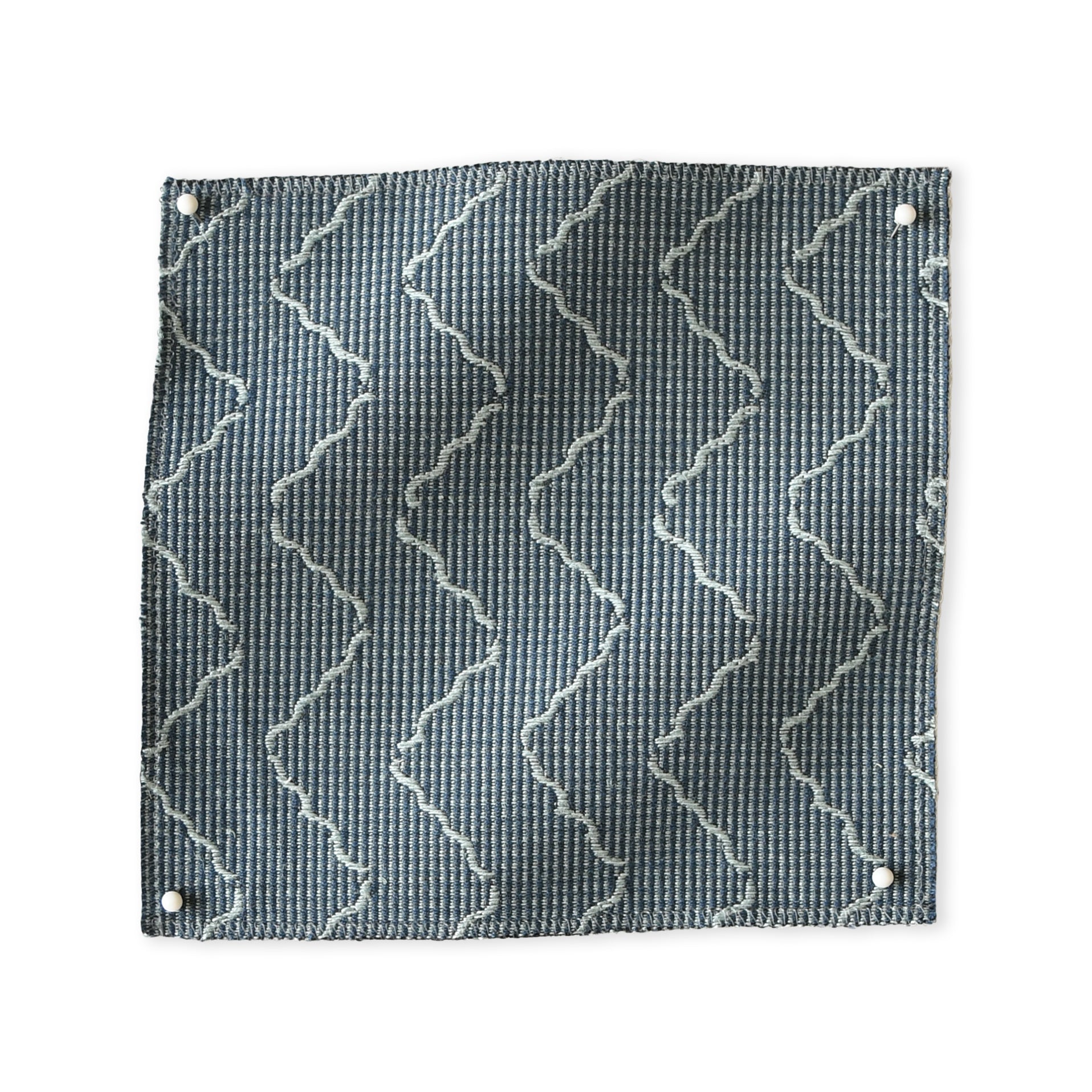 Pinned swatch of woven fabric with chevron stripe in slate blue. 