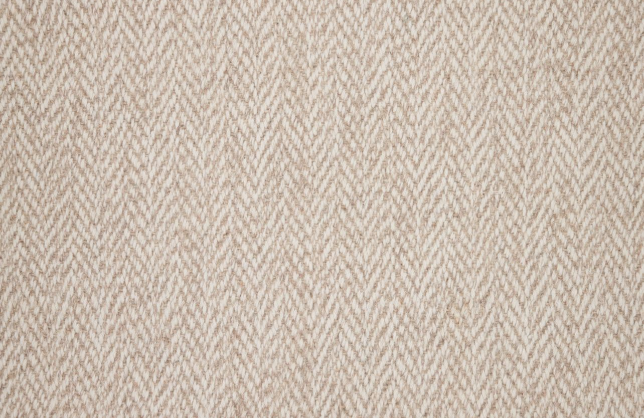 Broadloom carpet in a herringbone in warm beige.
