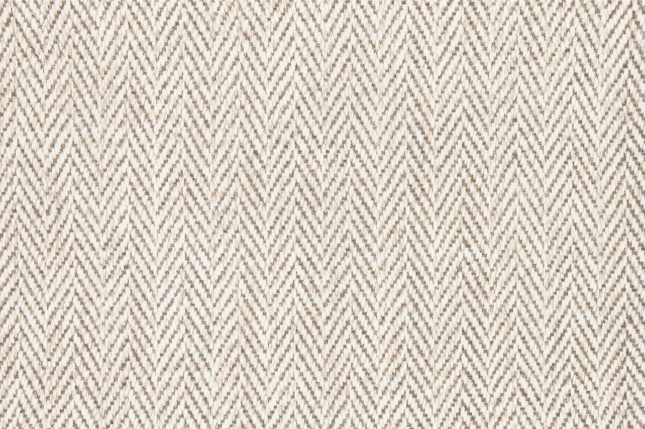 Broadloom carpet in a herringbone in cream and taupe. 