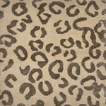 Handknotted rug with leopard spot motif in grey on cream. 