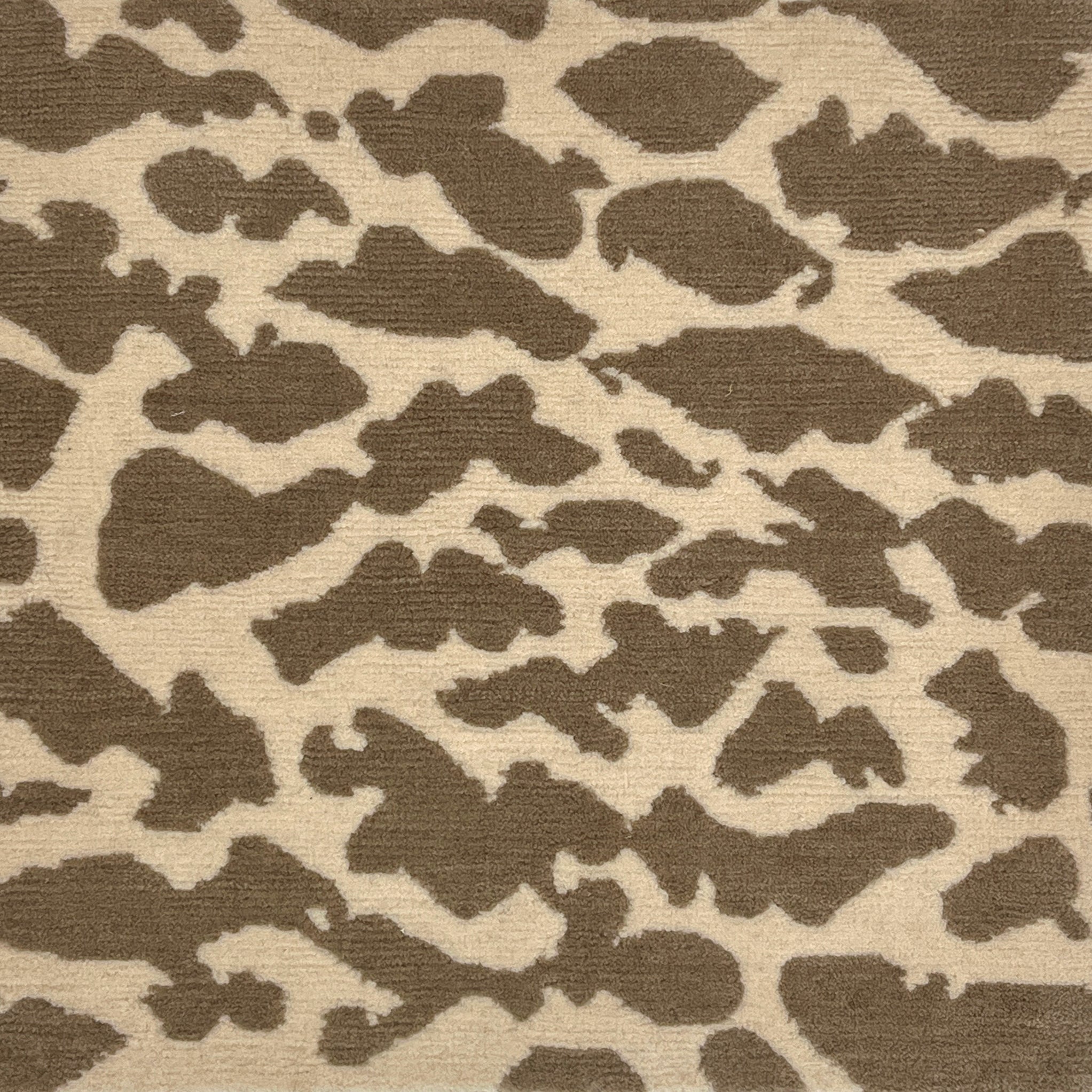 Handknotted rug with giraffe spot motif in light brown on cream. 