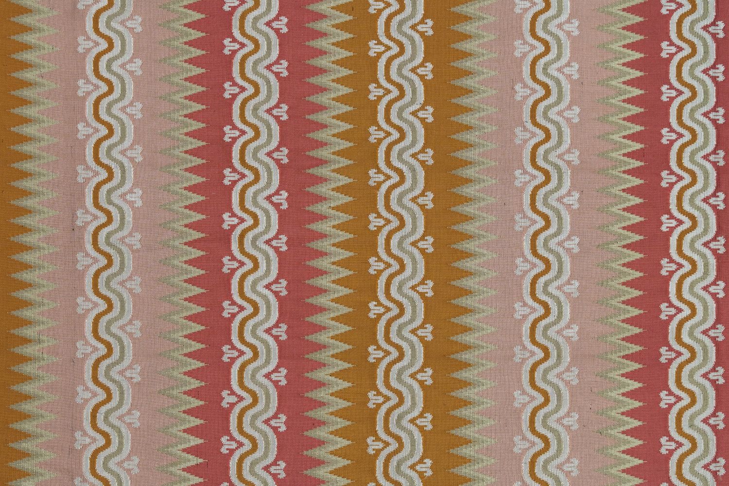 Handwoven silk fabric with wavy and zigzag designs in pink, red, orange, and green.