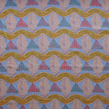 A close-up of a patterned fabric featuring repeating rows of stylized pink leaves, blue and red striped triangles and wavy orange-green lines on a blue background
