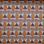 A close-up of a patterned fabric featuring repeating rows of stylized orange leaves, navy and red striped triangles and wavy orange-blue lines on a white background