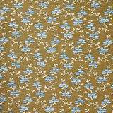 A close-up of a woven fabric pattern featuring a repeating geometric design of light blue diamond floral shapes and cream branch motifs on a warm tan background.