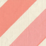 Fabric in a large-scale diagonal stripe print in shades of pink on a cream field.