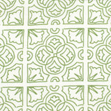 Detail of fabric in a damask lattice print in green on a white field.