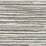 Detail of a grasscloth wallpaper in textured black and white on a paper backing.