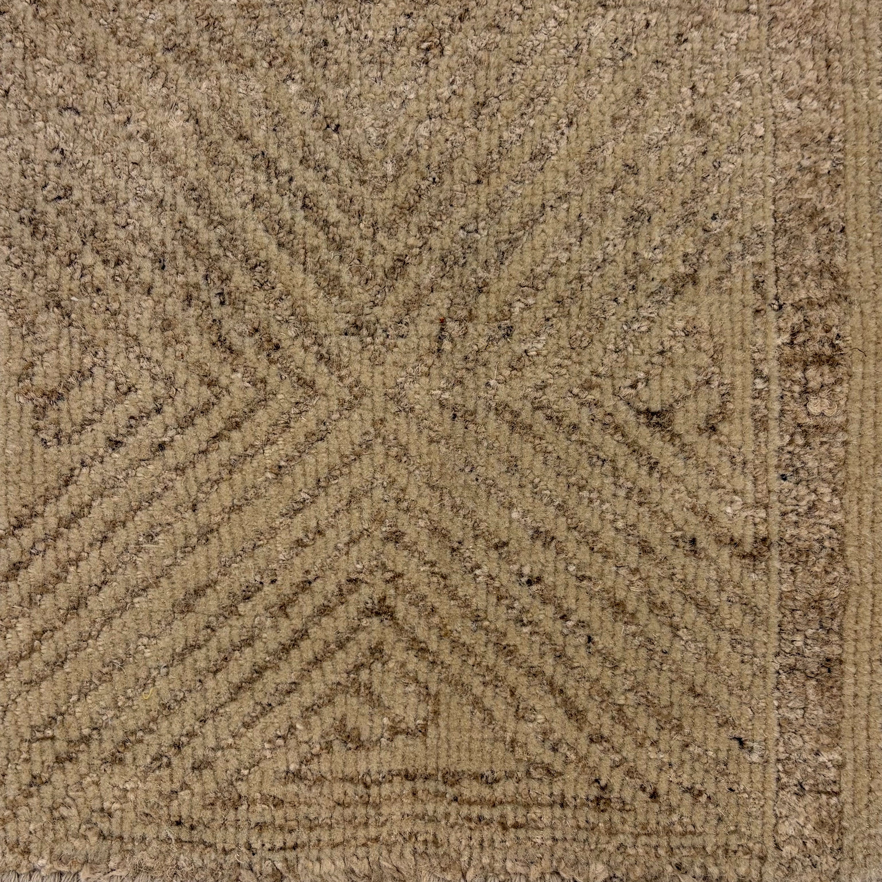 Close-up of a textured brown carpet with a subtle pattern