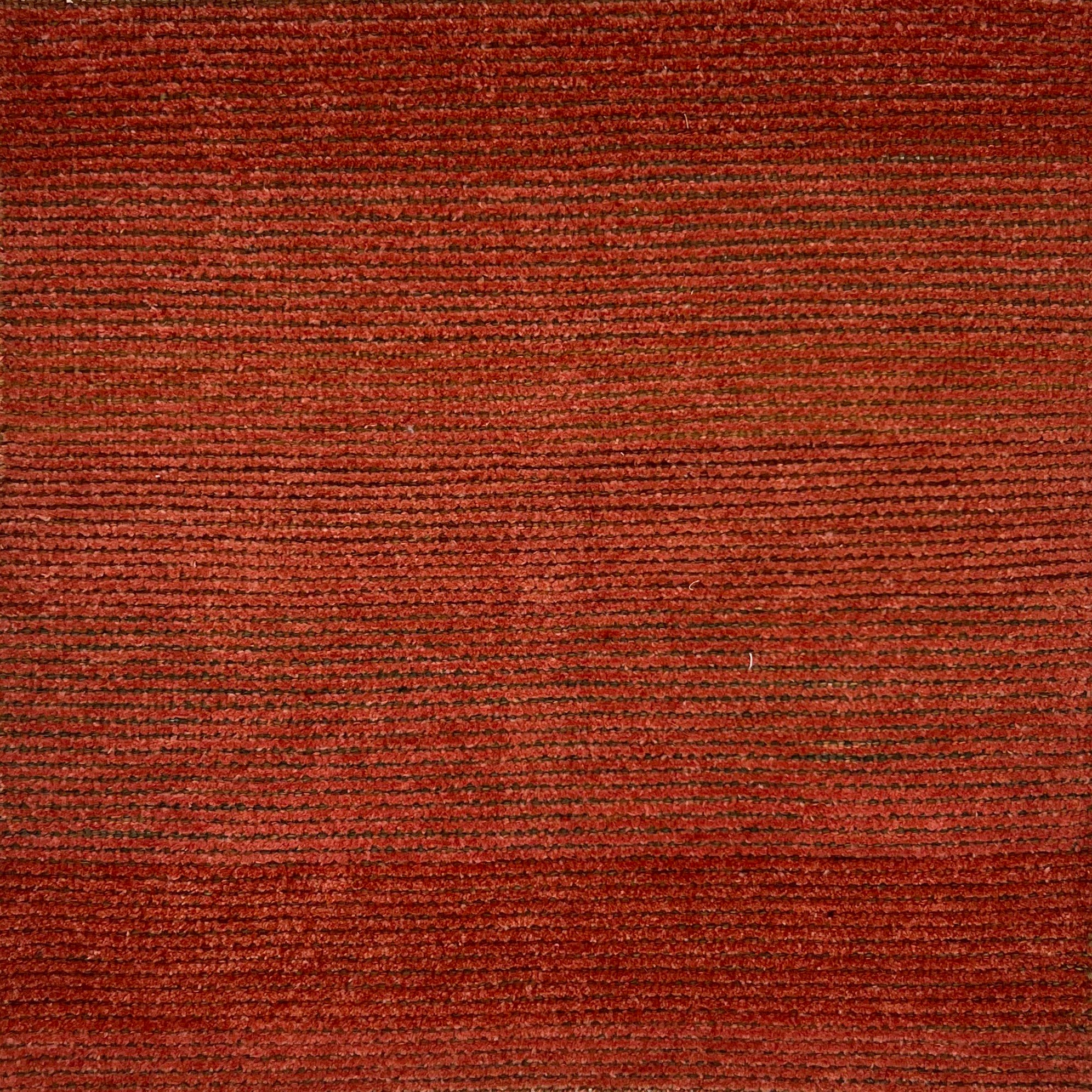 Handknotted rug in a burnt orange and brown weave.