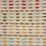 Handwoven wool rug with raised fringe multicolor stripes in pink, purple, cream green, turquoise and yellow on a beige field.