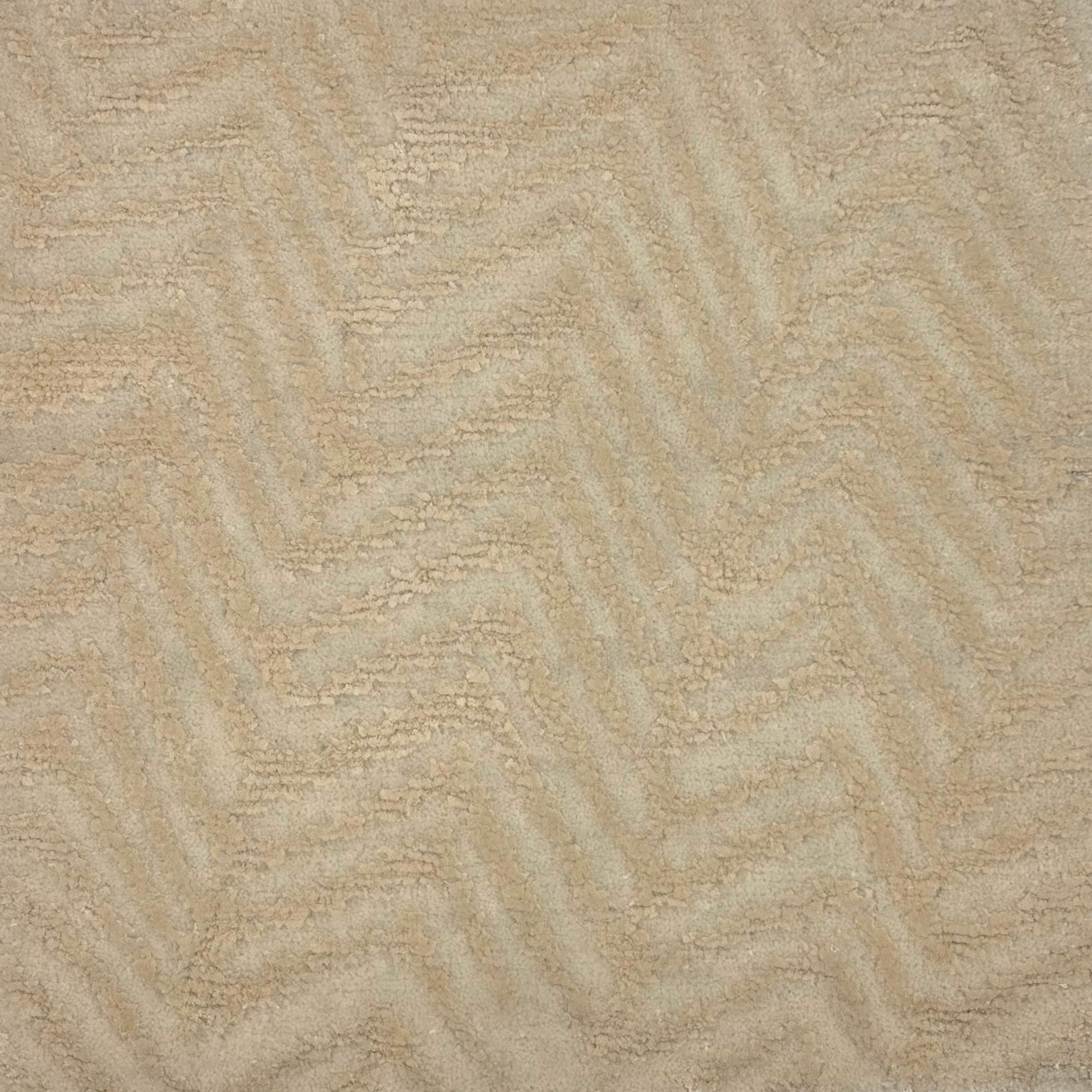 Handknotted rug with a tonal zig zag stripe in shades of cream. 