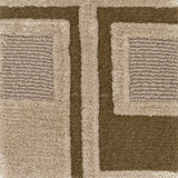 Close-up of a textured area rug with a geometric pattern in taupe, beige, and dark brown.
