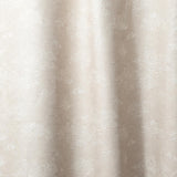 Draped fabric a painterly cloud pattern in white on a beige watercolor field.