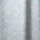 Draped fabric a painterly cloud pattern in white on a pastel blue watercolor field.