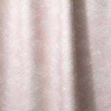 Draped fabric a painterly cloud pattern in white on a pastel pink watercolor field.