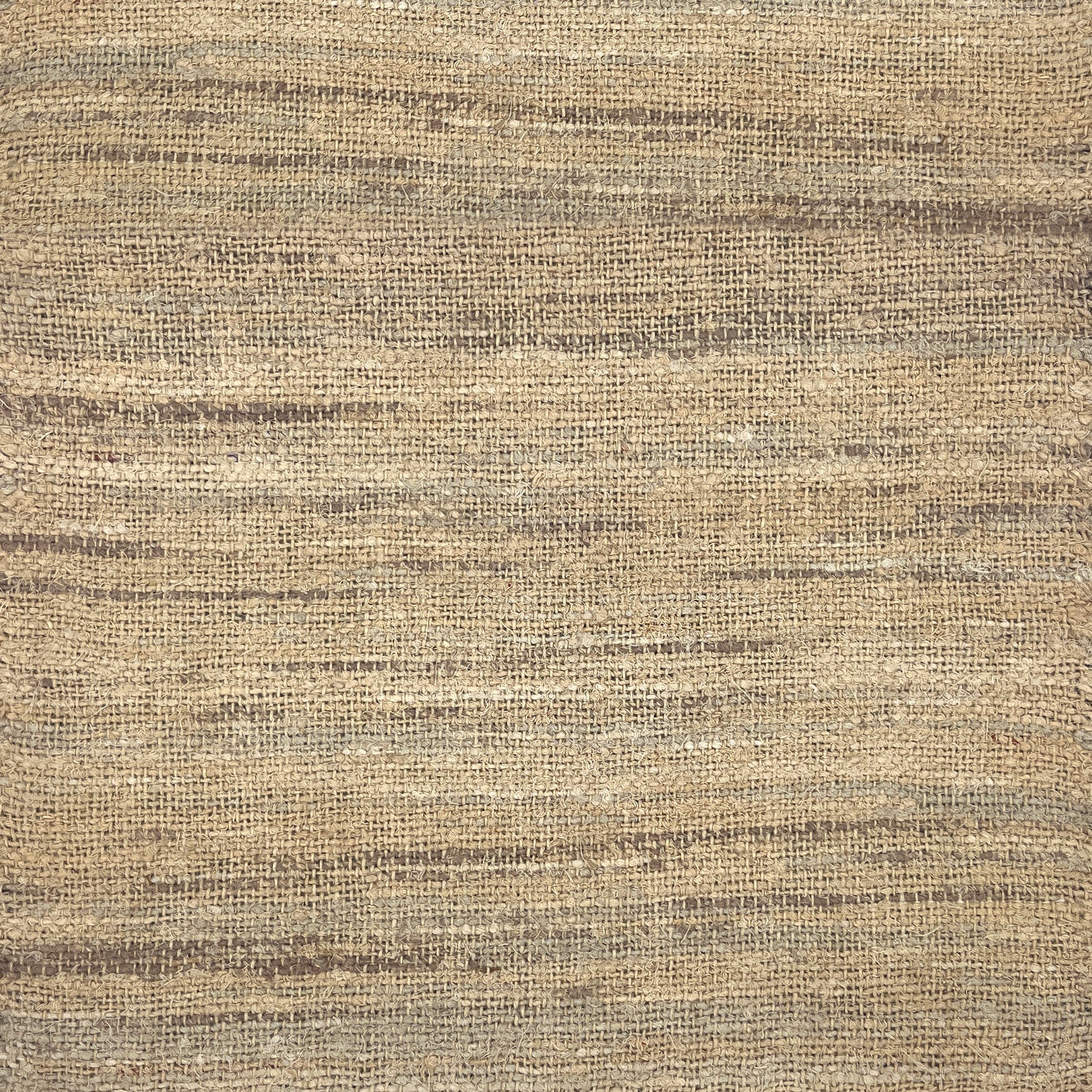 A close-up of a woven rug with a subtle striped texture in natural tan, beige, and brown tones.