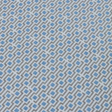 Detail of a wallpaper panel in a geometric grid print in shades of blue and gray.