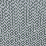 Detail of a wallpaper panel in a geometric grid print in shades of green, blue and gray.
