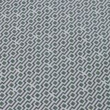 Detail of a wallpaper panel in a geometric grid print in shades of green, blue and gray.