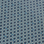 Detail of a wallpaper panel in a geometric grid print in shades of blue, red, navy and cream.