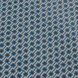 Detail of a wallpaper panel in a geometric grid print in shades of blue, red, navy and cream.