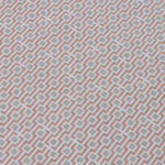Detail of a wallpaper panel in a geometric grid print in shades of pink and gray.