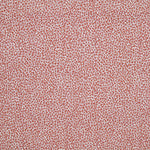 Fabric in a dappled animal print in shades of pink and purple on a cream field.