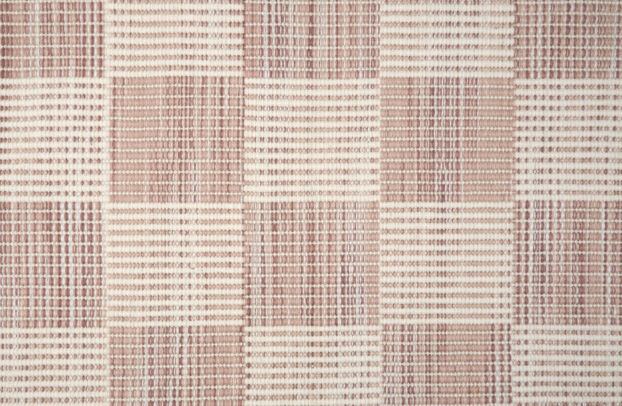 Broadloom carpet in a ribbed checkerboard pattern in cream and taupe.
