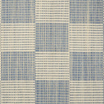 Broadloom carpet in a ribbed checkerboard pattern in cream and light blue. 