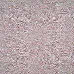 Fabric in a dappled animal print in shades of red and turquoise on a cream field.