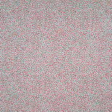 Fabric in a dappled animal print in shades of red and turquoise on a cream field.