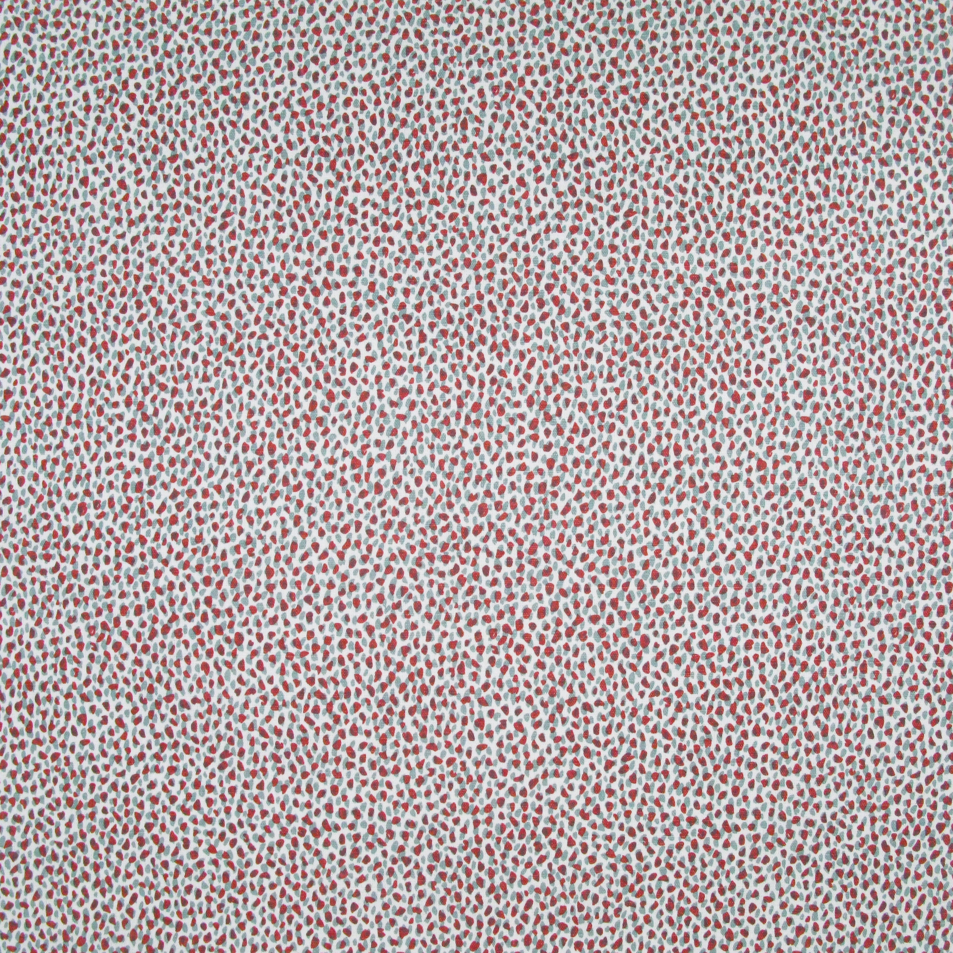 Fabric in a dappled animal print in shades of red and turquoise on a cream field.