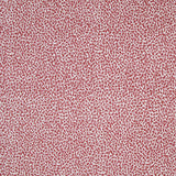 Fabric in a dappled animal print in shades of red and purple on a cream field.